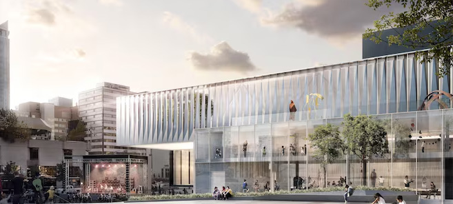 Musée à Montréal avec façade vitrée et aménagement urbain animé.